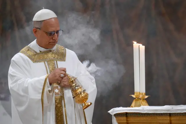 Pope Leo holding an incense burner and waving it next to the Altar