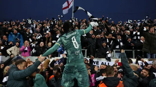 Yves Bissouma celebrates with the Tottenham fans after their win at Bodo/Glimt