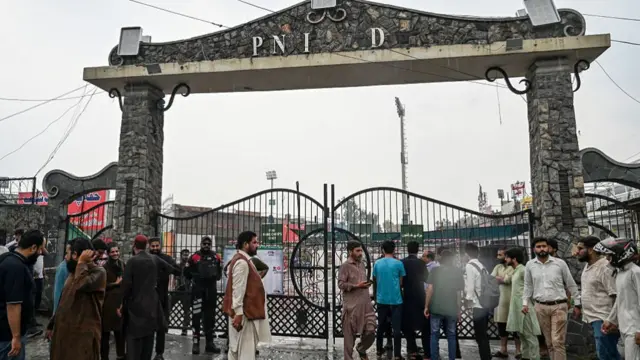 People gather outside a street near the Rawalpindi cricket stadium after an alleged drone was shot down in Rawalpindi on May 8, 2025.