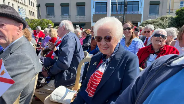 Maureen St George sat amongst a crowd of people at an event in Jersey on Liberation Day 2025