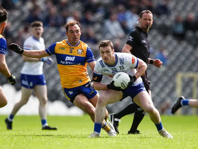 Killian Lavelle of Monaghan in action against Alan Sweeney of Clare