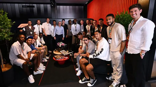 England players pose with F1 CEO Stefano Domenicali