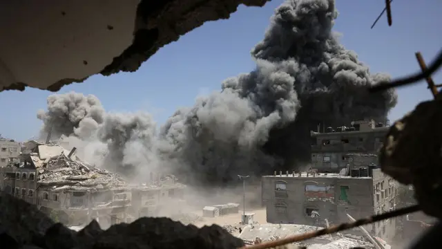 Smoke and debris rise following an Israeli strike on a house west of Jabalia, in the northern Gaza Strip