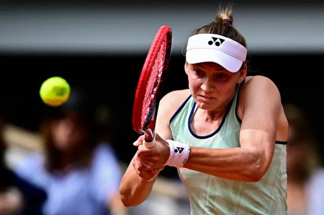 Kazakhstan's Elena Rybakina plays a backhand return to Poland's Iga Swiatek
