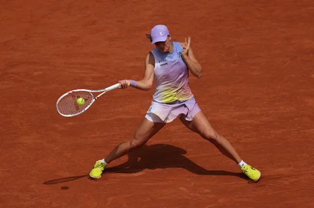 Iga Swiatek of Poland plays a forehand against Elena Rybakina