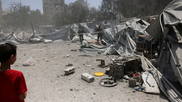 People check the destruction after an Israeli strike on a house west of Jabalia