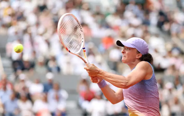 Iga Swiatek of Poland plays a backhand against Elena Rybakina