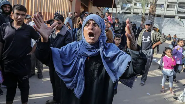 A woman appears to cry out with her arms in the air