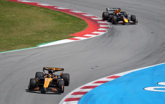 Oscar Piastri leading with Max Verstappen behind him