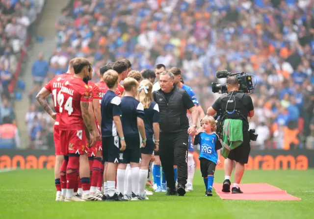 Oldham Athletic manager Micky Mellon greets players ahead of the Vanarama National League play-off final at Wembley Stadium, London.