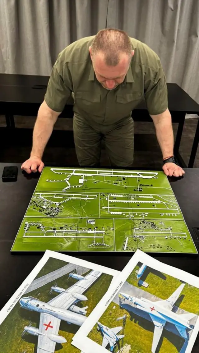 A handout photo made available by the Ukrainian Security Service (SBU) Telegram Channel on 01 June 2025 shows the head of the Security Service Vasyl Malyuk, studying a photo of a map of Russia's strategic aviation location at an undisclosed location in Ukraine