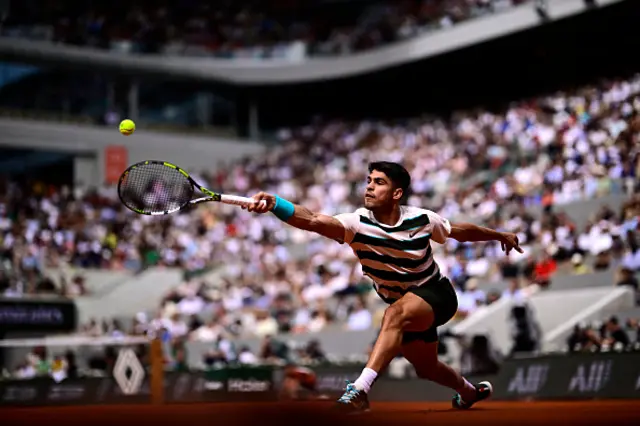 Spain's Carlos Alcaraz plays a backhand return