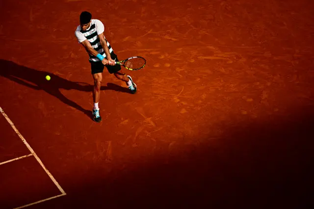 Spain's Carlos Alcaraz plays a backhand return