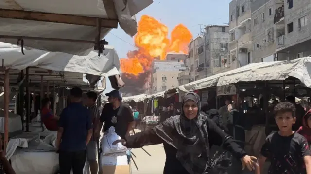 Smoke and flames rise from a house hit by an Israeli strike in Gaza City