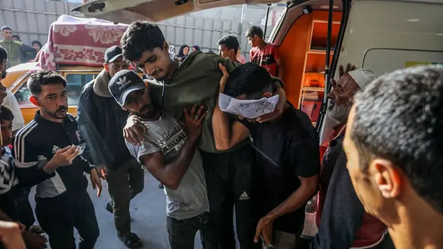 A man is helped out of an ambulance
