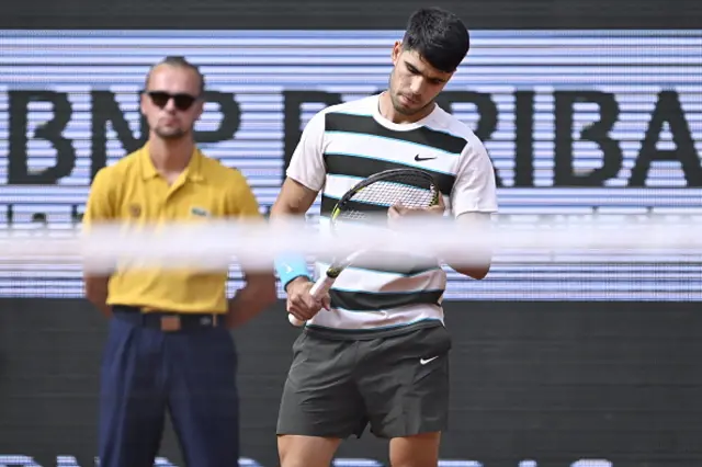 Carlos Alcaraz of Spain looks at his racquet