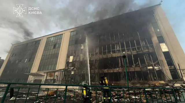 Firefighters tackle a blaze caused by an air strike at a building in Odesa