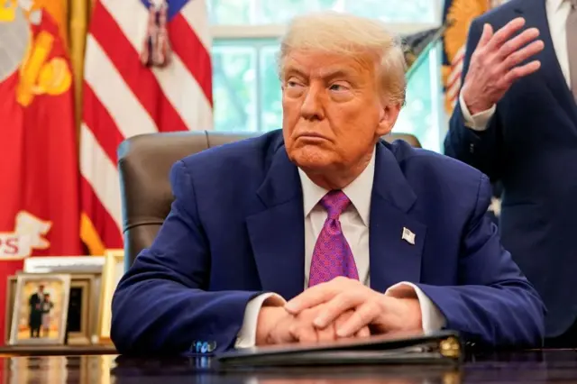 President Donald Trump sits in the Oval Office