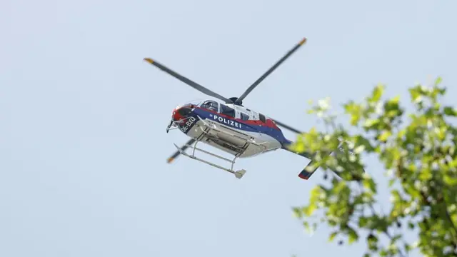 Helicopter flies over a tree