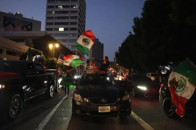 Protesters wave Mexican flags during protests sparked by immigration raids in Los Angeles