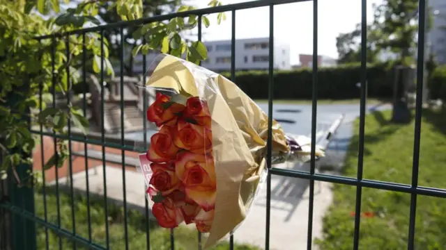 A flower bouquet is placed in tribute to the victims, at the fence of the Dreierschutzengasse high school following a shooting in Graz, Austria