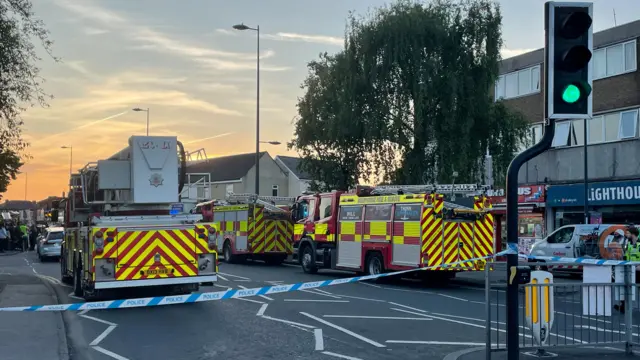 Three fire engines and a gas van parked within the cordon