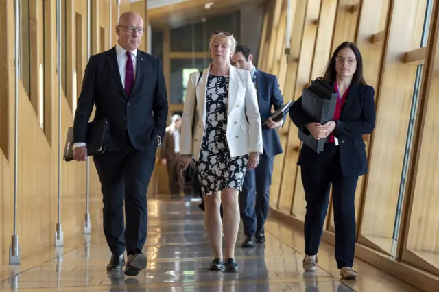 First Minister of Scotland John Swinney, Finance Secretary Shona Robison and Deputy First Minister of Scotland Kate Forbes arrive for First Minister's Questions at the Scottish Parliament in Holyrood, Edinburgh.