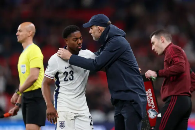 Myles Lewis-Skelly and Thomas Tuchel embrace