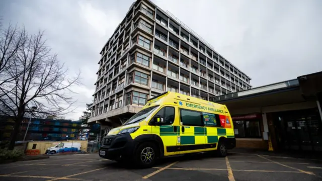 The hospital and an NHS ambulance is seen in front of the hospital