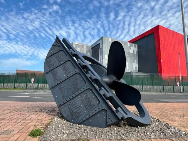 A replica submarine propeller monument honours the long history of shipbuilding in Barrow-in-Furness, opposite the BAE systems site