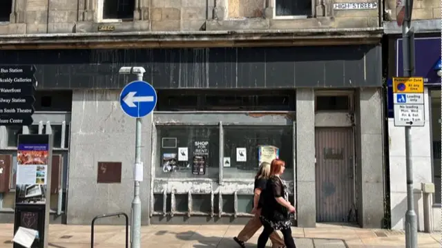 Two women walk on Kirkcaldy high street