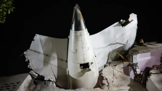 The wreckage of the tail section of the crashed Air India plane seen stuck in a building in Ahmedabad, western India. Photo: 12 June 2025an Air India aircraft