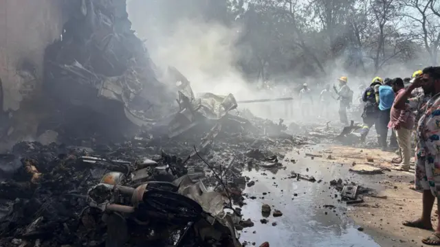 Smouldering wreckage after an airliner crashed in Ahmedabad, India, on 12 June
