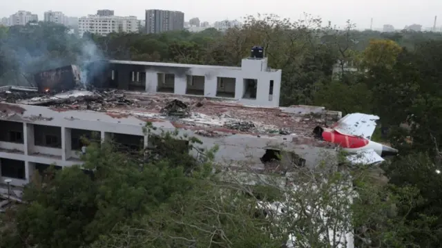 Plane sticking out of a building.