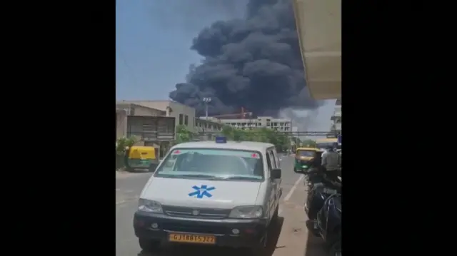 Smoke billows behind an ambulance