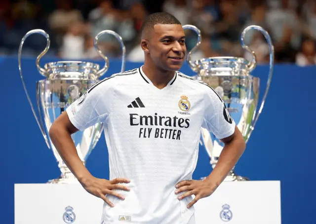 Kylian Mbappe with the Champions League trophy