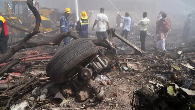 Debris at the site of a plane crash near Sardar Vallabhbhai Patel International Airport