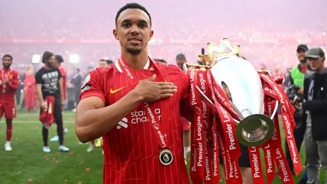 Trent Alexander-Arnold of Liverpool, celebrates with Premier League trophy after his final appearance for Liverpool