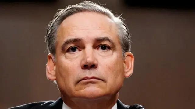 Close up of middle-aged white man with grey-white hair. It's Boeing CEO Kelly Ortberg, sitting down in a black suit