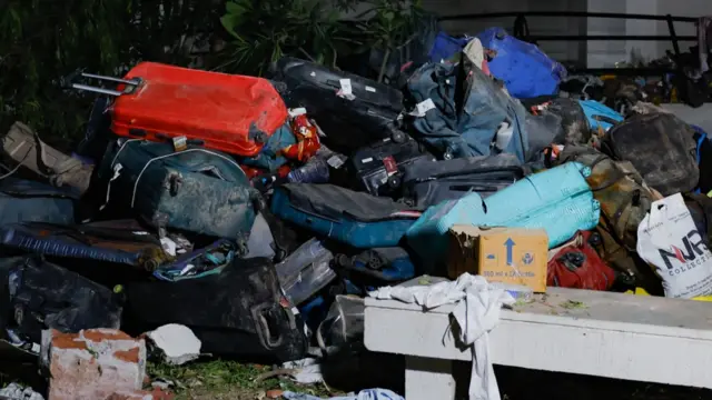 Passengers' luggage scattered at the crash site in Ahmedabad. Photo: 12 June 2025