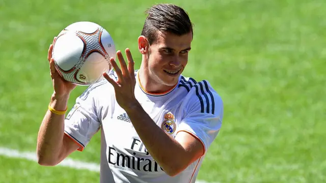 Gareth Bale gestures on the pitch during his presentation at the Santiago Bernabeu