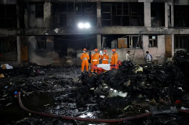 Rescuers work at the plane crash site in Ahmedabad. Photo: 12 June 2025