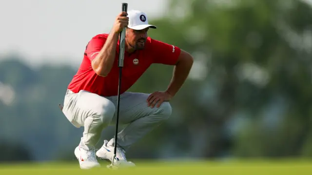 Bryson DeChambeau lines up a putt