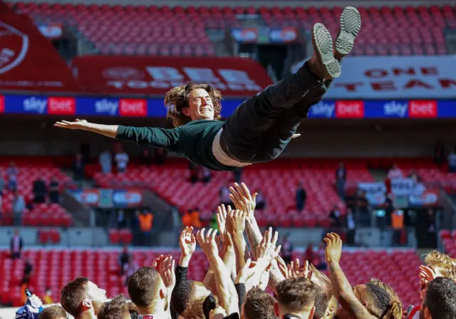 Thomas Frank is tossed into the air after guiding Brentford to promotion from the Championship in the play-off final