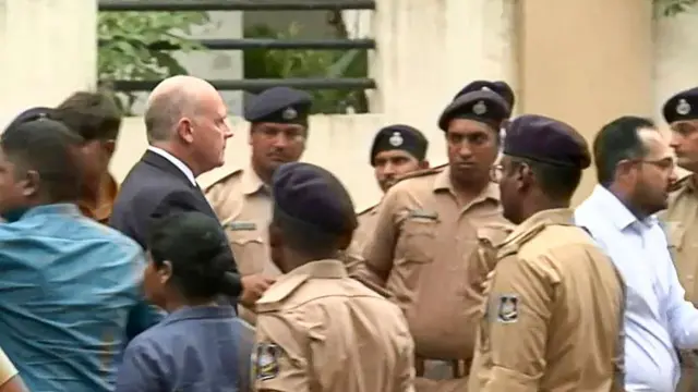 This frame grab from AFPTV video footage taken on June 13, 2025 shows Air India's chief executive officer (CEO) Campbell Wilson (2nd L) arriving at the crash site of Air India flight 171 in Ahmedabad. Rescue teams with sniffer dogs combed the crash site