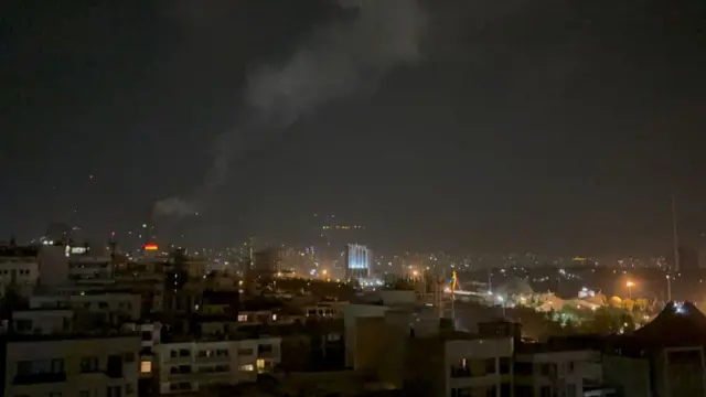 Smoke rises from a location allegedly targeted in Israel's wave of strikes on Tehran, Iran, on early morning of 13 June