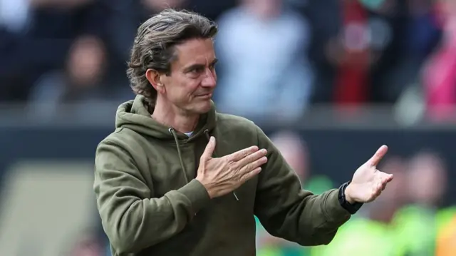 Brentford manager Thomas Frank pats the badge