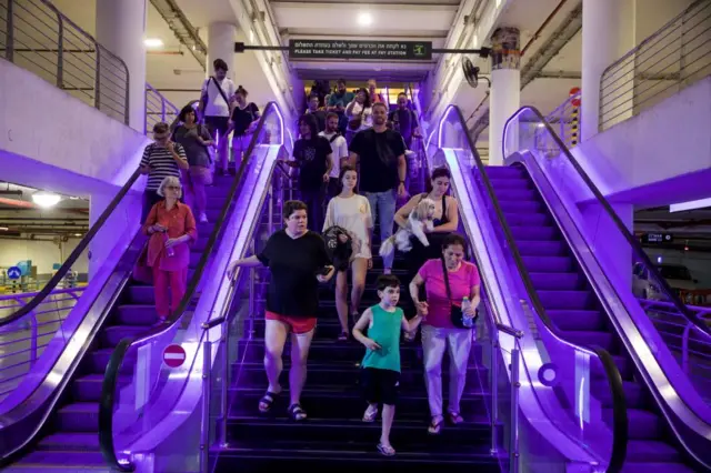 People go down escalator