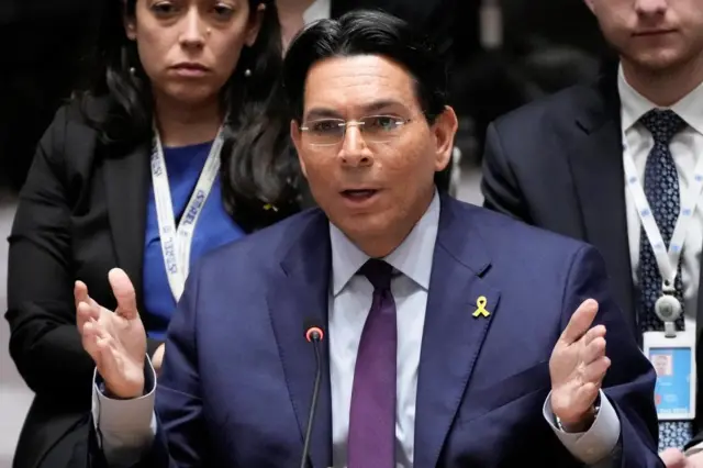 Man in suit gestures with his hands