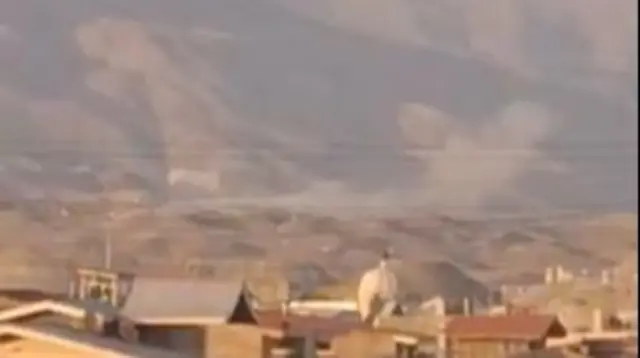 A screengrab from the new footage showing smoke plumes to the west of Tehran